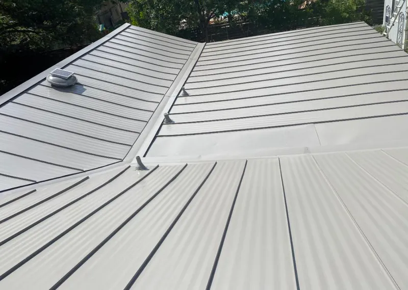 Solar attic fan installed on a metal roof for Roof Ventilation in St. Michael